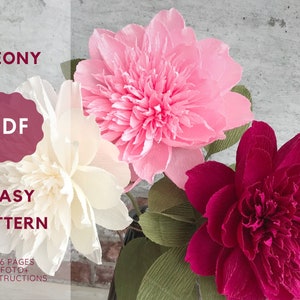 Handmade crepe paper peony flowers in pink, white, and deep red with green leaves