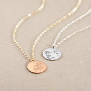 Mini flower disc pendant necklace with small coin-shaped charms on a delicate chain