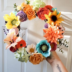 Felt flower wreath with multicolor blooms and twig base