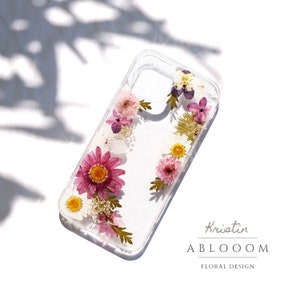 Pressed flower phone case with clear background and pink, yellow and white floral design