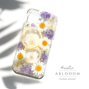 Pressed flower phone case, clear with purple and yellow daisies and a lemon slice design