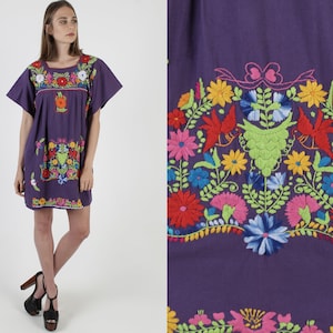 Purple embroidered mini dress with short sleeves and vibrant floral front, straight hem.