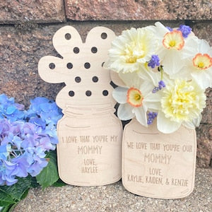 Cream flower holder cutouts with circular handle, engraved 'Love you Mommy'