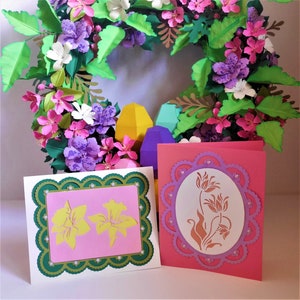 Two Easter flower greeting cards with scalloped frames and pastel floral designs