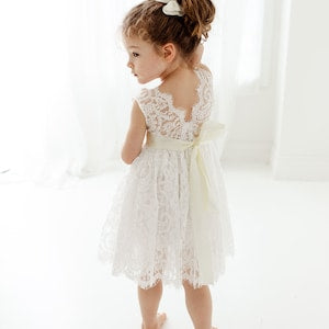 White flower girl dress with lace bodice and layered tulle skirt, sleeveless