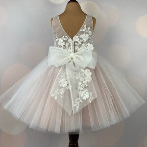 Blush tulle flower girl dress with lace appliques and satin bow