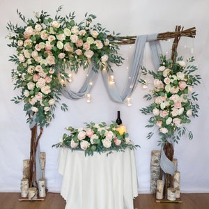 Peach, blush and ivory wedding flower archway with wooden accents and draped fabric