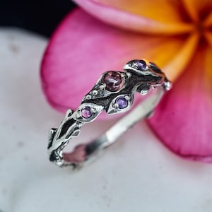 Silver-tone leaf and berry ring with small purple stones along the band