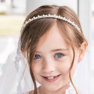 Pearl and rhinestone headband worn in child hair