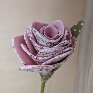 Lavender fabric faux rose with layered petals and white patterned details