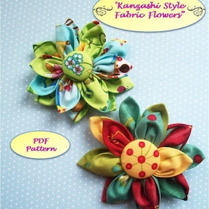Two Kanzashi-style fabric flowers in green, blue, and red with colorful button centers