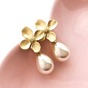 Gold flower pearl drop earrings with dangling white teardrop pearls