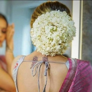 White floral hair bun accessory with reusable gajra for bridal updo