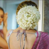 White floral hair bun accessory with reusable gajra for bridal updo