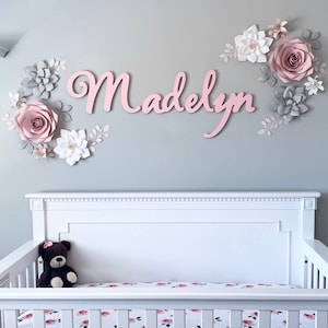 Paper flower name backdrop with pastel blooms and 'Madelyn' script