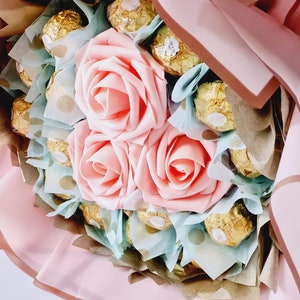 Chocolate and flower bouquet with pink rose and assorted wrapped chocolates
