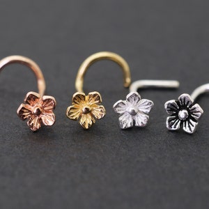 Flower nose studs set with tiny flower heads in rose gold, gold, silver, and black tones