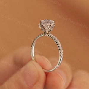 Floral diamond engagement ring with pavé band and rose-shaped center stone