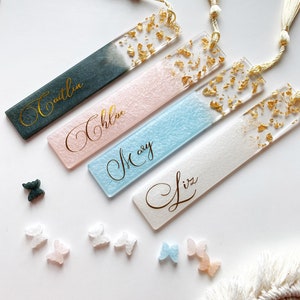 Set of resin bookmarks with cursive names and gold flake accents, rectangular shape