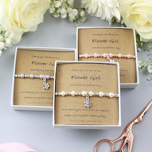 Pearl beaded bracelet set on gift cards, with small flower charm and clasp