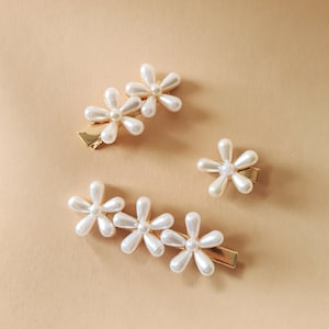 Pearl flower hair clips set with white faux pearls on gold-tone metal