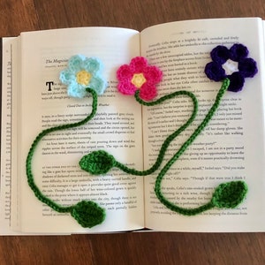 Crochet flower bookmark set with pink, purple blooms and green stems and leaves