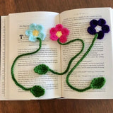 Crochet flower bookmark set with pink, purple blooms and green stems and leaves