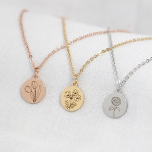 Birth flower necklace with round engraved floral pendant in rose gold, gold, and silver tones