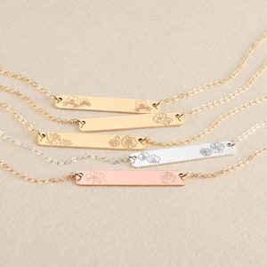 Birth flower bar necklaces with engraved charms on thin chains, in gold, rose gold, and silver