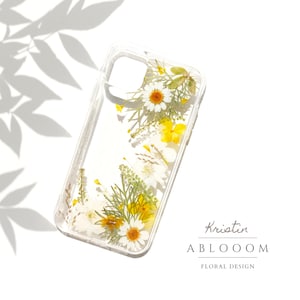 Pressed flower phone case with clear background and yellow daisies