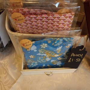 Handmade twin set cotton pouches: blue floral and pink patterned fabric, with zipper