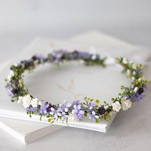 Floral flower crown with lavender and white blossoms and green leaves