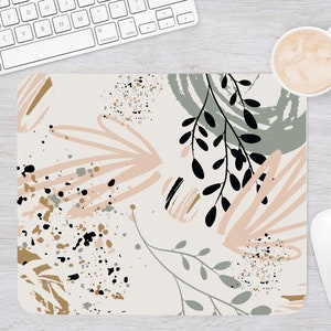 Floral mouse pad with pink accents, green leaves, and speckled botanical design