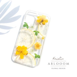 Clear phone case with pressed yellow flowers and green leaves, slim protective cover