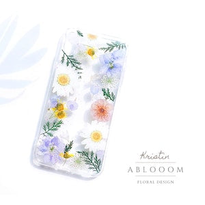Clear pressed flower phone case with daisies and wildflowers pattern