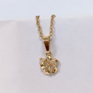 Small hibiscus flower pendant necklace with gold-tone chain