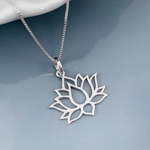 Silver lotus flower pendant necklace with a linked chain and small clasp