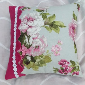 Vintage rose garden pillow case with pink and white roses, green leaves, and lace trim border
