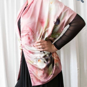 Pink butterfly and floral multi-use scarf/shawl, draped over shoulders