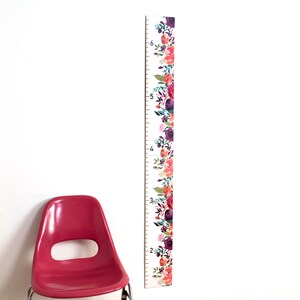 Floral wooden height growth chart with rose print and height markings
