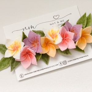 Floral flower crown headband with pink, orange, and yellow blossoms and green leaf accents