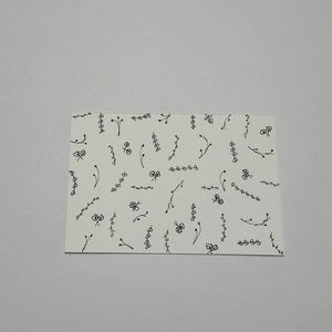 Hand-drawn tiny flower postcard with small black floral line drawings