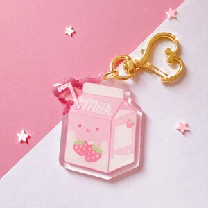 Strawberry pink acrylic keychain charm shaped like a milk carton with stars