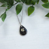 Pendant drop shape with real dried flowers "Spirea Van Houtte" on black resin. Ideal gift for a loved one