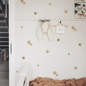 Removable fabric wall stickers with small tan flower decals