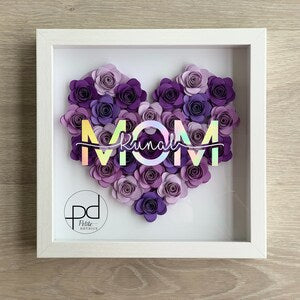 White paper flower shadow box with purple flower heart and decorative ribbon text