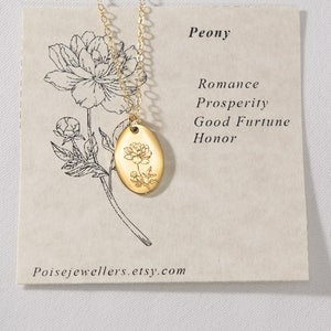 Gold-tone peony pendant necklace with oval locket on delicate chain