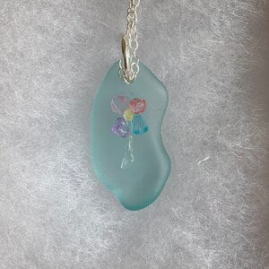 Aqua sea glass pendant with tropical flower design and silver chain