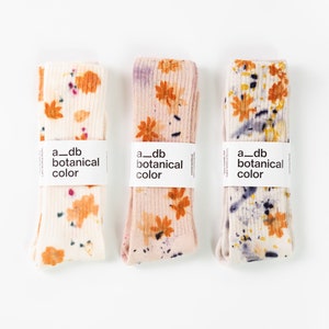 Bamboo plant-dyed socks with orange floral pattern and purple/black accents
