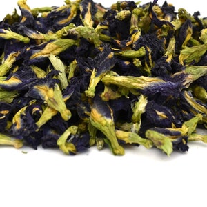 Dried butterfly pea flowers, dark blue and yellow-green petals, for herbal tea infusion